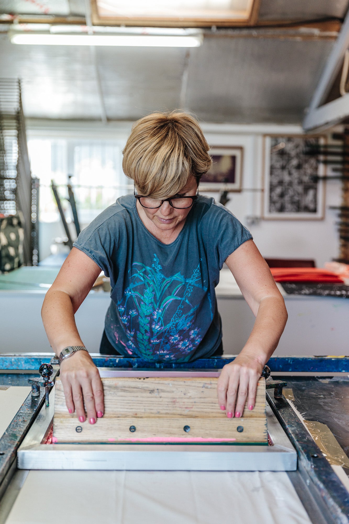 Load video: video of Steph Driver of LucasLoves demonstrating the screen printing process onto fabric.